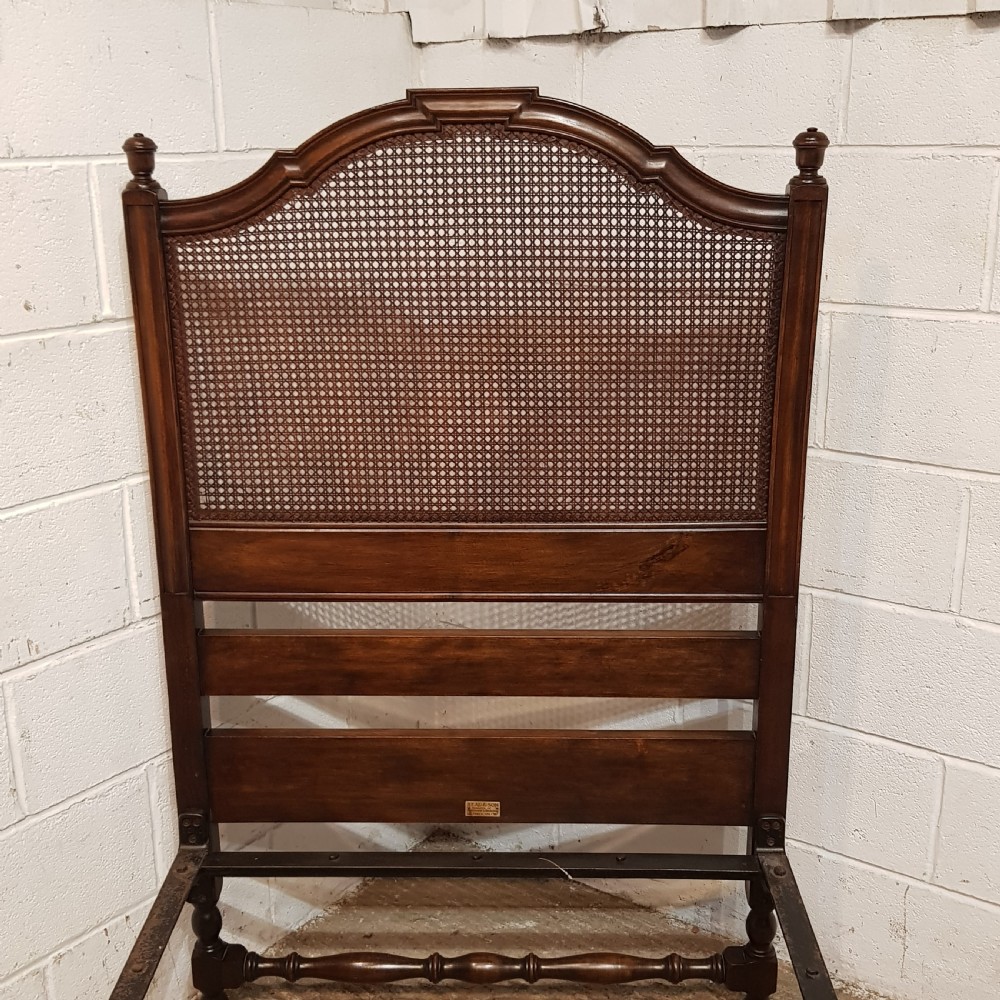 BY HEALS OF LONDON AN ANTIQUE PAIR OF WALNUT FRAMED SINGLE BEDS WITH BERGERE PANELS C1900 View V