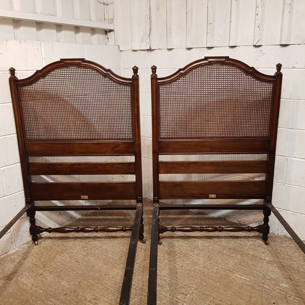 BY HEALS OF LONDON AN ANTIQUE PAIR OF WALNUT FRAMED SINGLE BEDS WITH BERGERE PANELS C1900 View VI