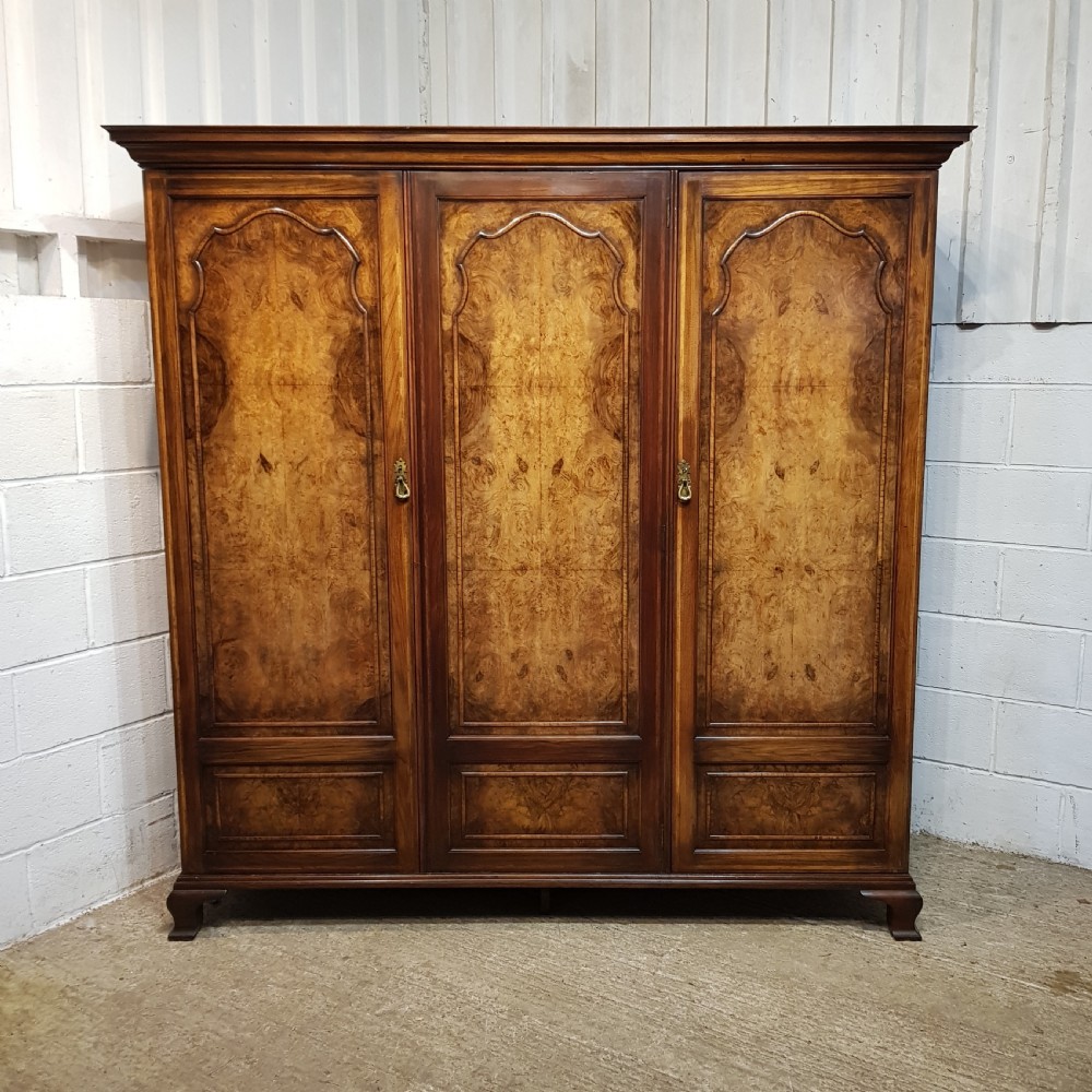 AN ANTIQUE BURR WALNUT TRIPLE WARDROBE C1920