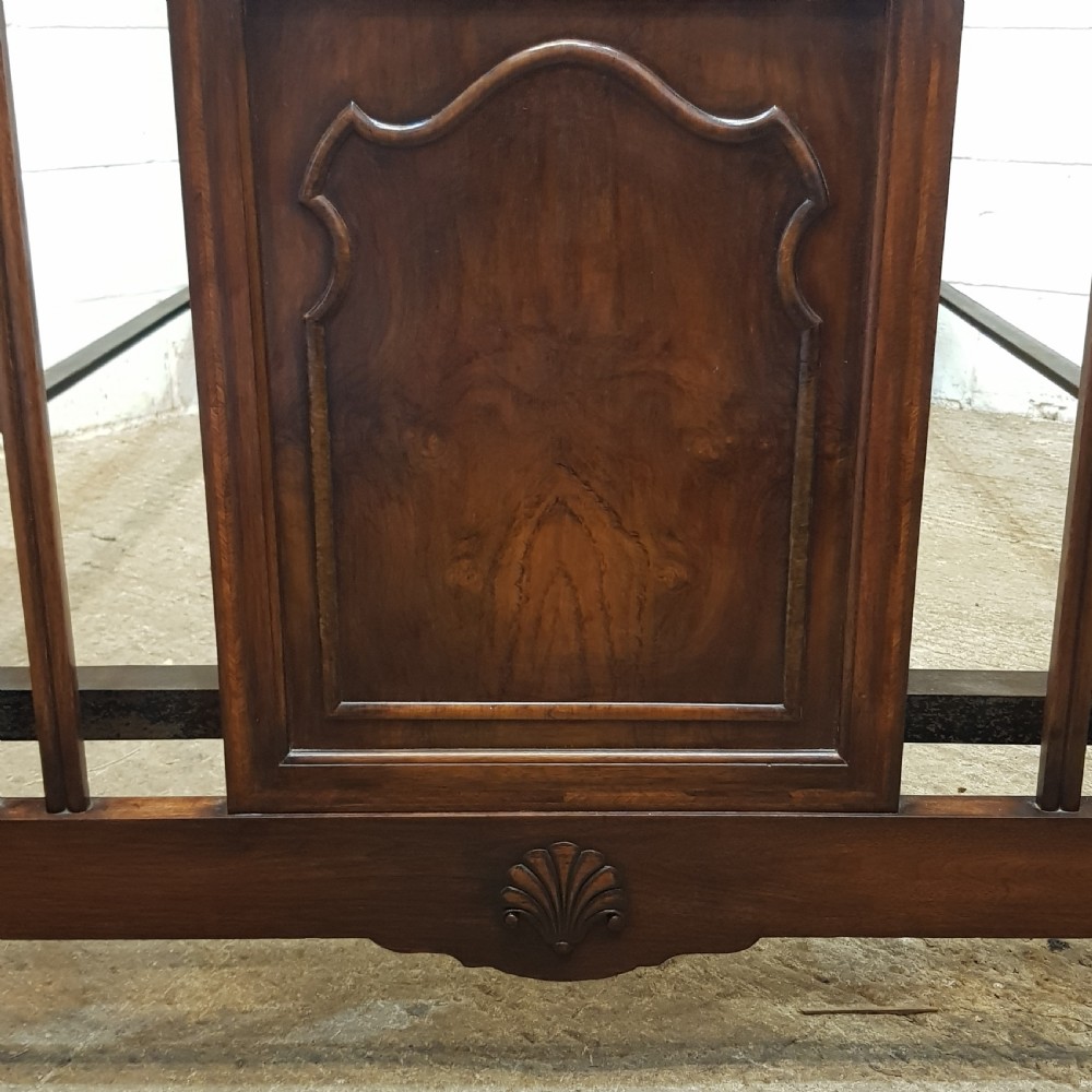 An antique dark walnut double bedstead featuring a central arched panel flanked by vertical slats on both the headboard and footboard, set with metal side rails. View III