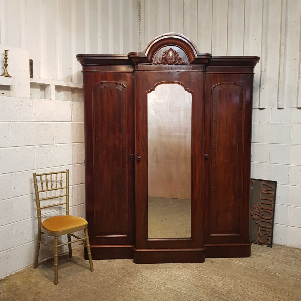 AN ANTIQUE VICTORIAN MAHOGANY BREAKFRONT TRIPLE WARDROBE C1860