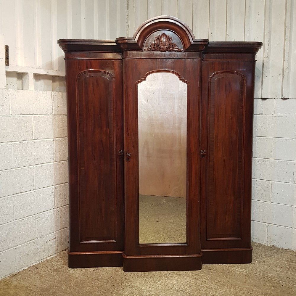 AN ANTIQUE VICTORIAN MAHOGANY BREAKFRONT TRIPLE WARDROBE C1860 View V