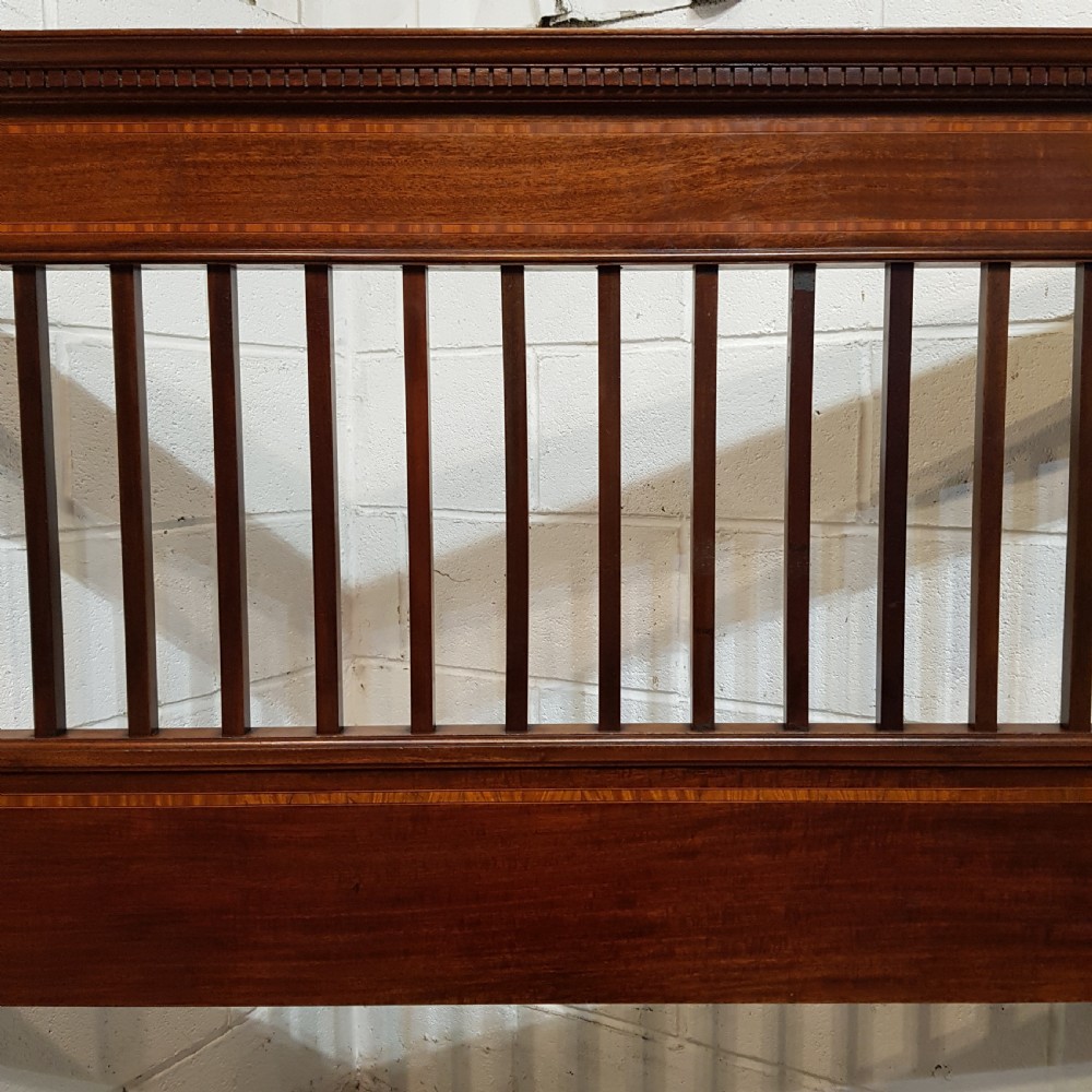 An Edwardian mahogany king size bedstead featuring vertical slatted panels on both headboard and footboard, decorated with fine wood inlay. View III
