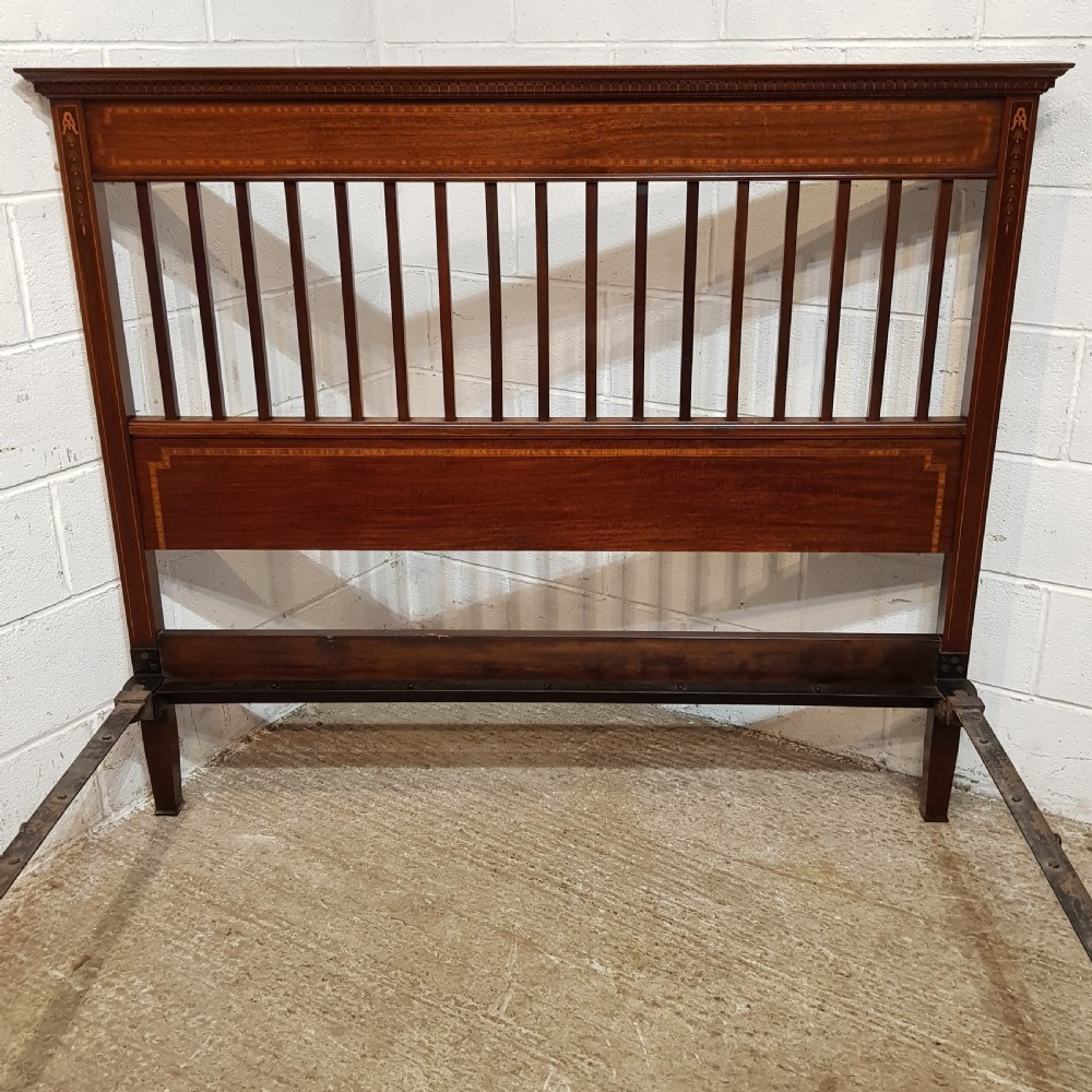 An Edwardian mahogany king size bedstead featuring vertical slatted panels on both headboard and footboard, decorated with fine wood inlay. View V