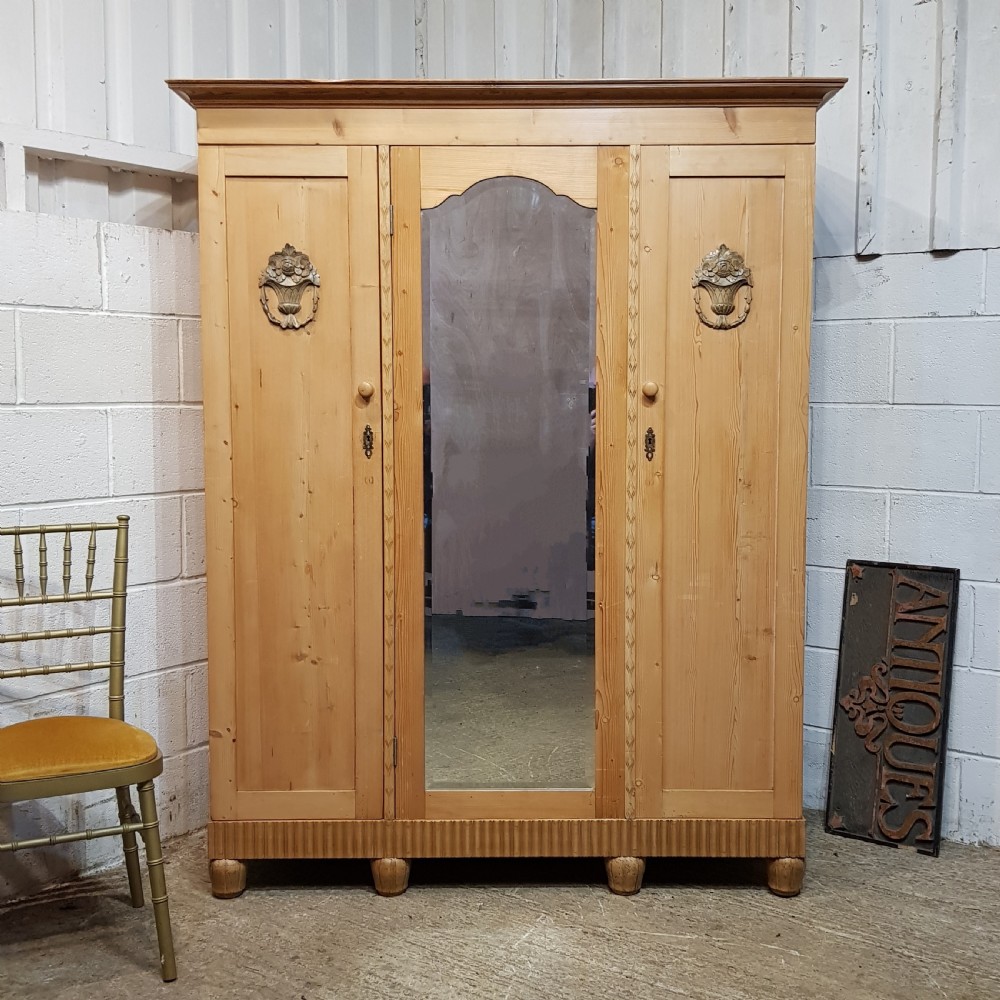 A LATE VICTORIAN SMALL PINE TRIPLE WARDROBE C1900