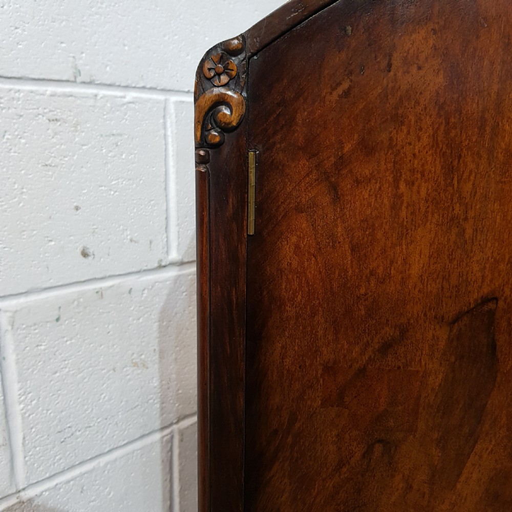 A 1920s burr walnut tallboy featuring an arched top two-door cabinet over three wide drawers with ornamental brass handles and cabriole feet. View V