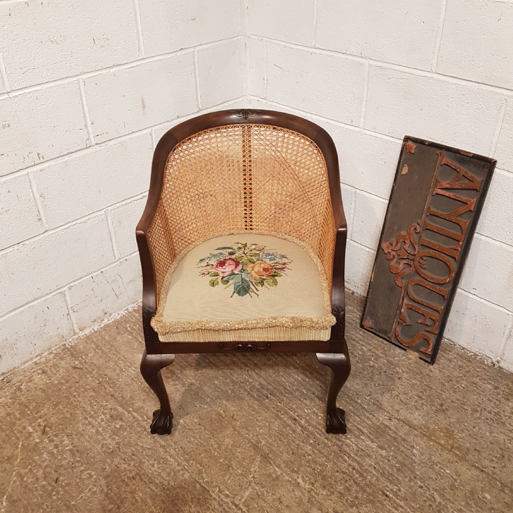 A DENBY & SPINKS MAHOGANY FRAMED BERGERE BACKED TUB CHAIR C1920
