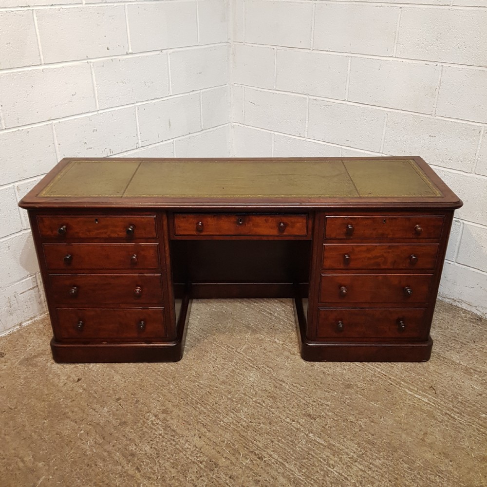 A VICTORIAN LONG MAHOGANY DESK C1880