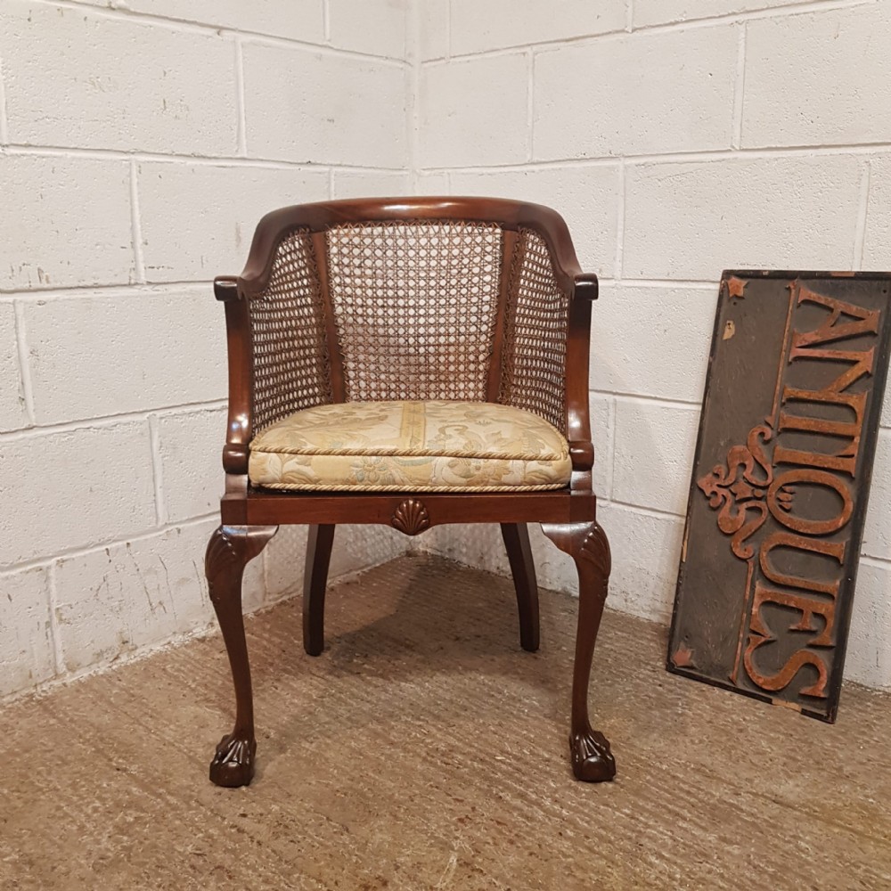 AN ANTIQUE MAHOGANY BERGERE TUB CHAIR C1920