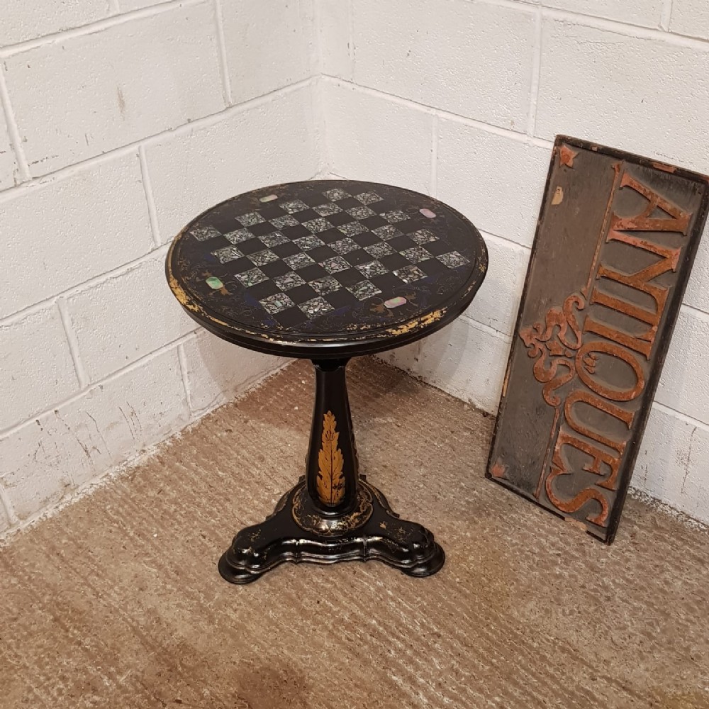 A VICTORIAN TIP TOP EBONISED PAPIER MACHE ROUND CHESS TABLE C1880
