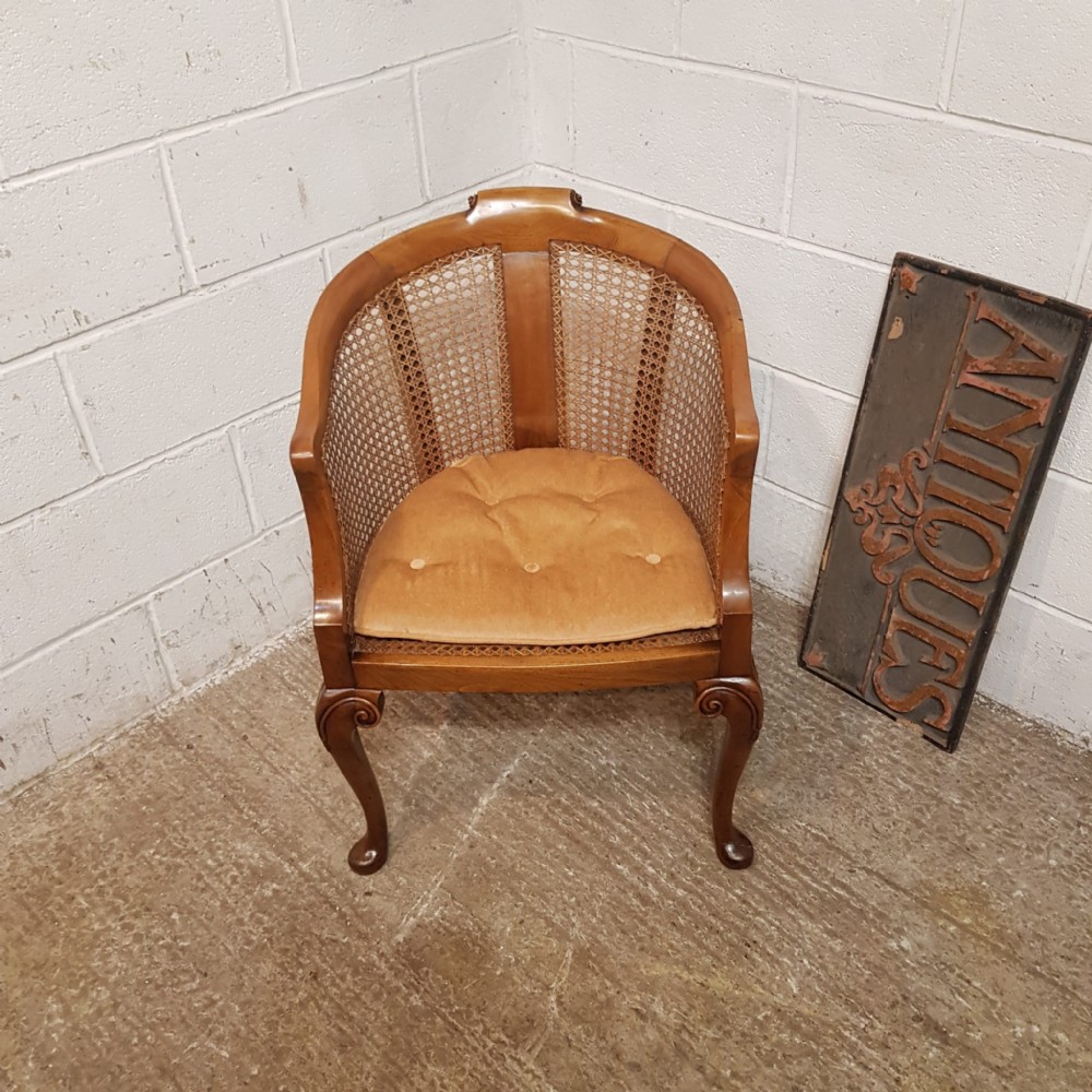 AN EDWARDIAN BERGERE WALNUT FRAMED TUB CHAIR C1900