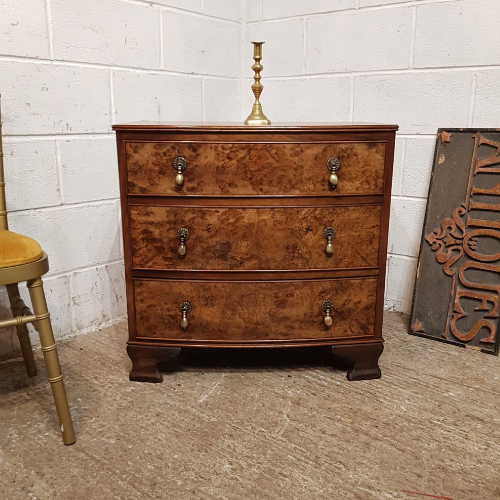 A WALNUT BOW FRONTED 3 HEIGHT CHEST C1920