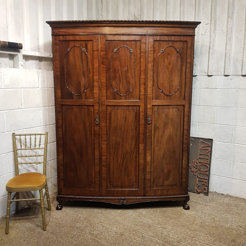 AN EDWARDIAN MAHOGANY TRIPLE BOW FRONTED WARDROBE C1900