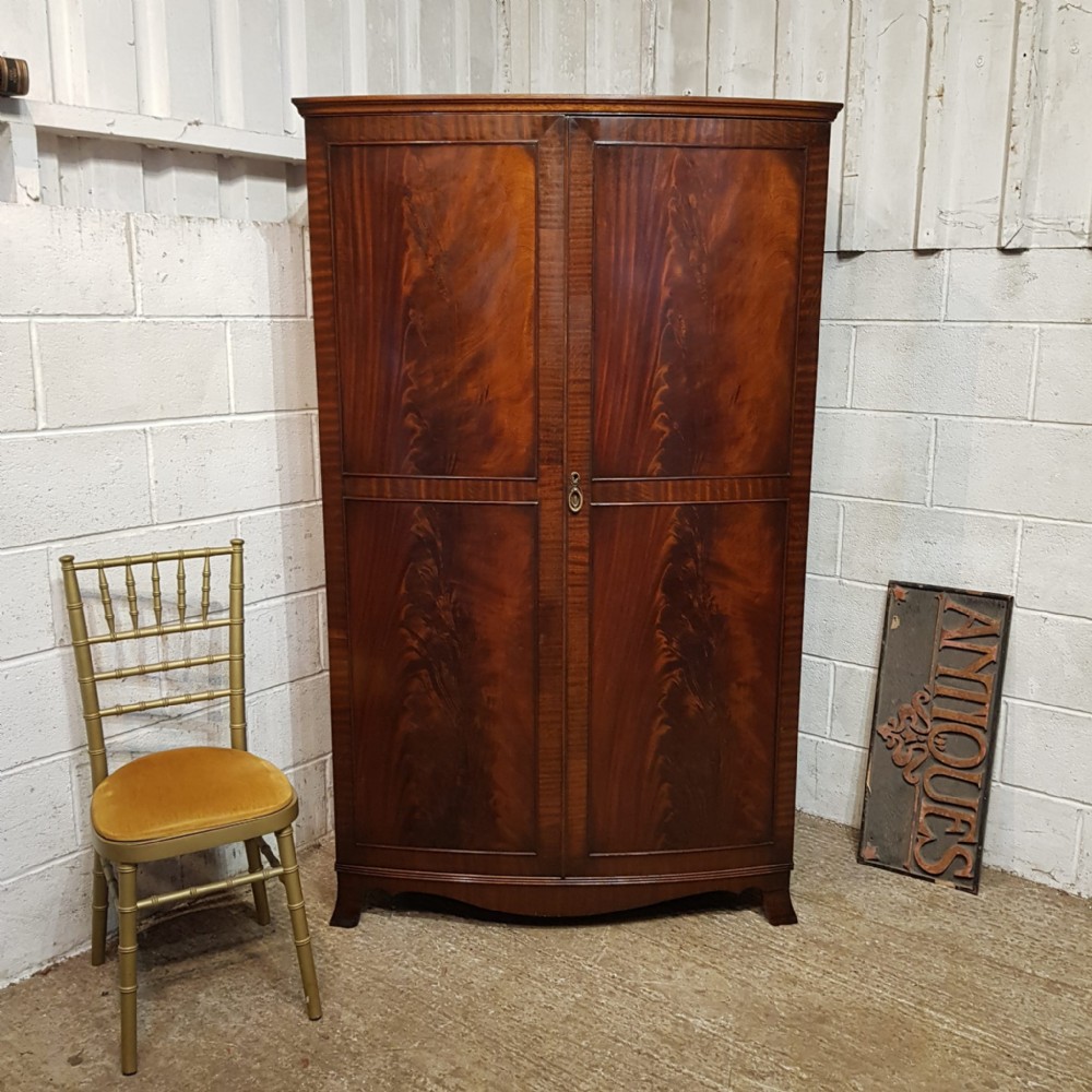 A BOW FRONTED MAHOGANY TRIPLE WARDROBE C1920