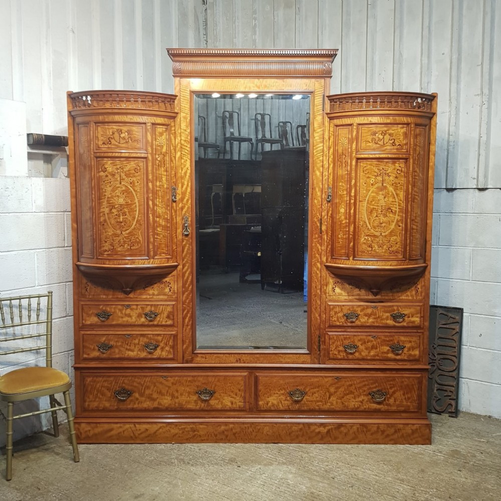 A SATINWOOD HEAVILY INLAID TRIPLE WARDROBE BY SHAPLAND AND PETTER OF BARNSTABLE C1890
