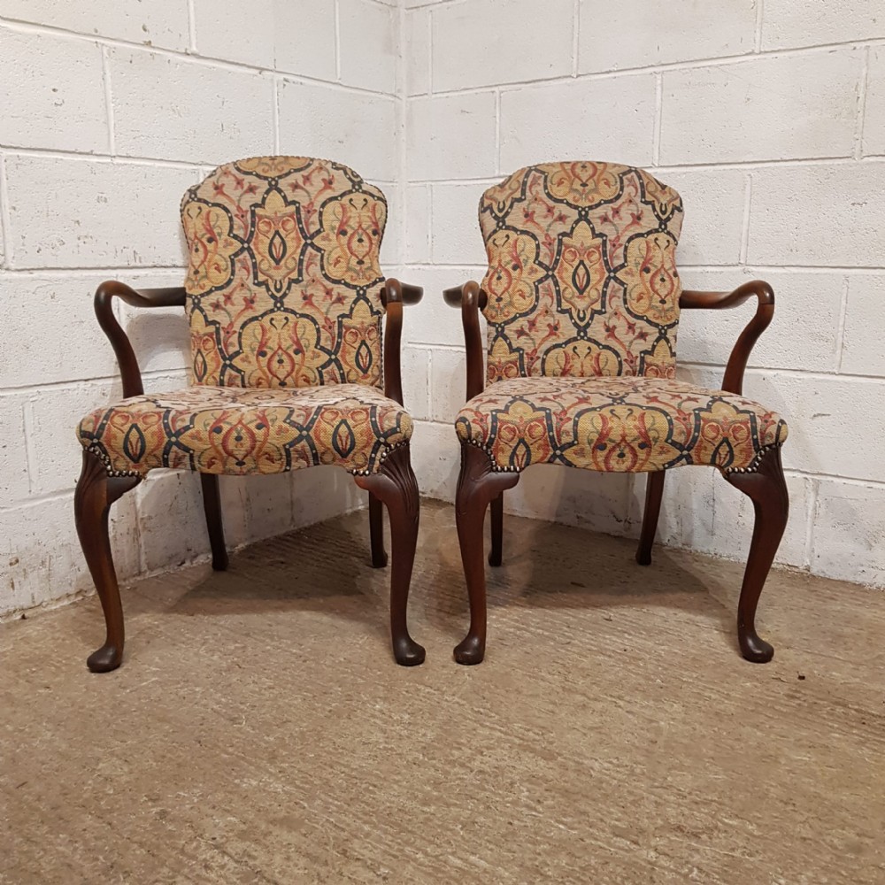 A PAIR OF WALNUT FRAMED LIBRARY CHAIRS C1920