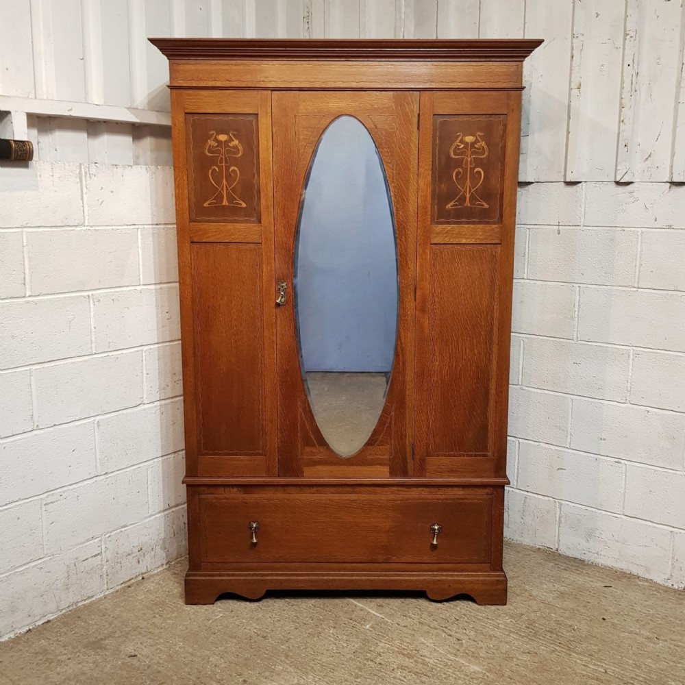 AN ARTS & CRAFTS OAK WARDROBE C!900