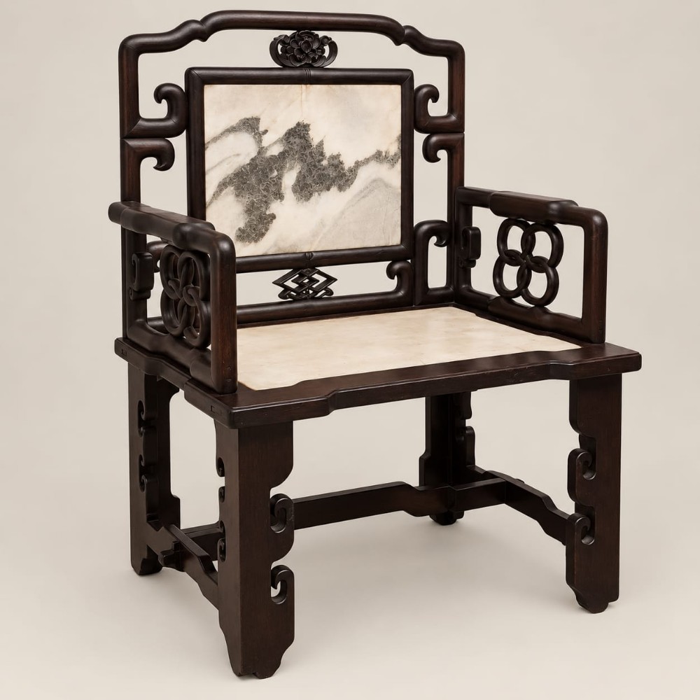 A late Qing dynasty Chinese dark hardwood armchair featuring an inlaid mottled marble backrest panel and seat.