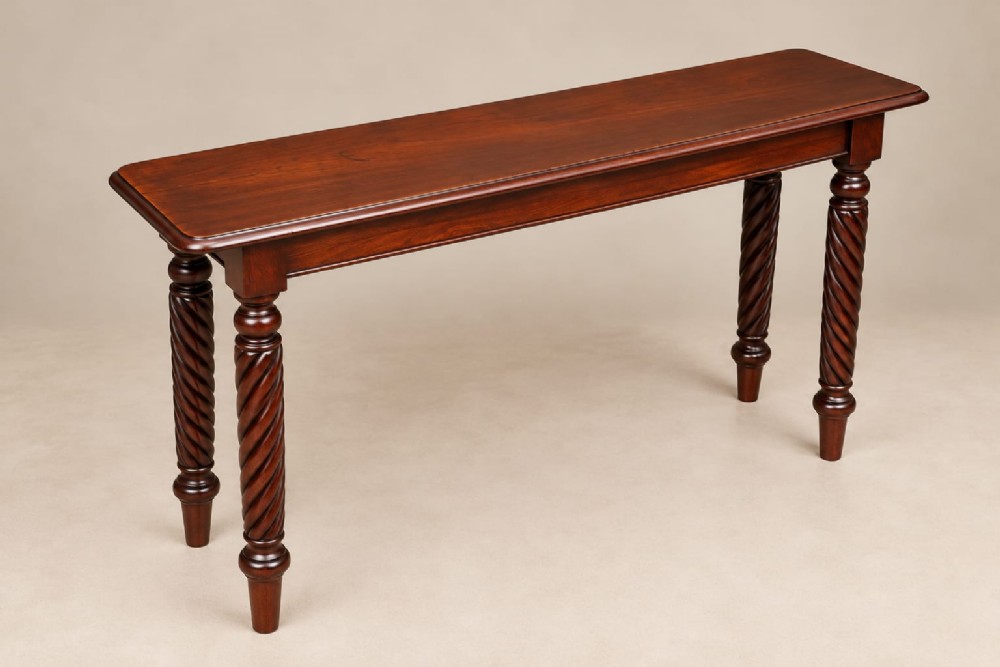 A late Victorian mahogany console table featuring a rectangular top with a moulded edge and four barley twist turned legs.
