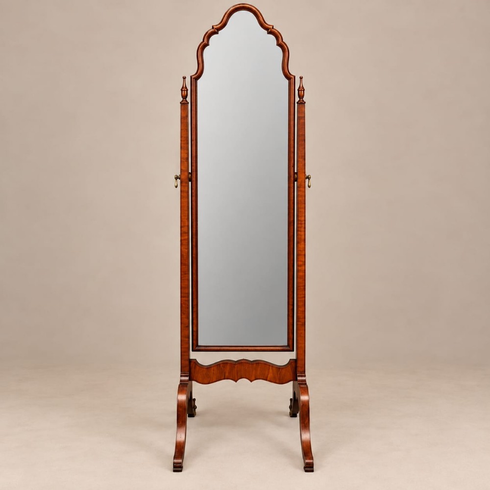 A full-length 1920s burr walnut cheval mirror featuring a shaped arched top frame, twin side uprights topped with turned finials, and splayed legs.