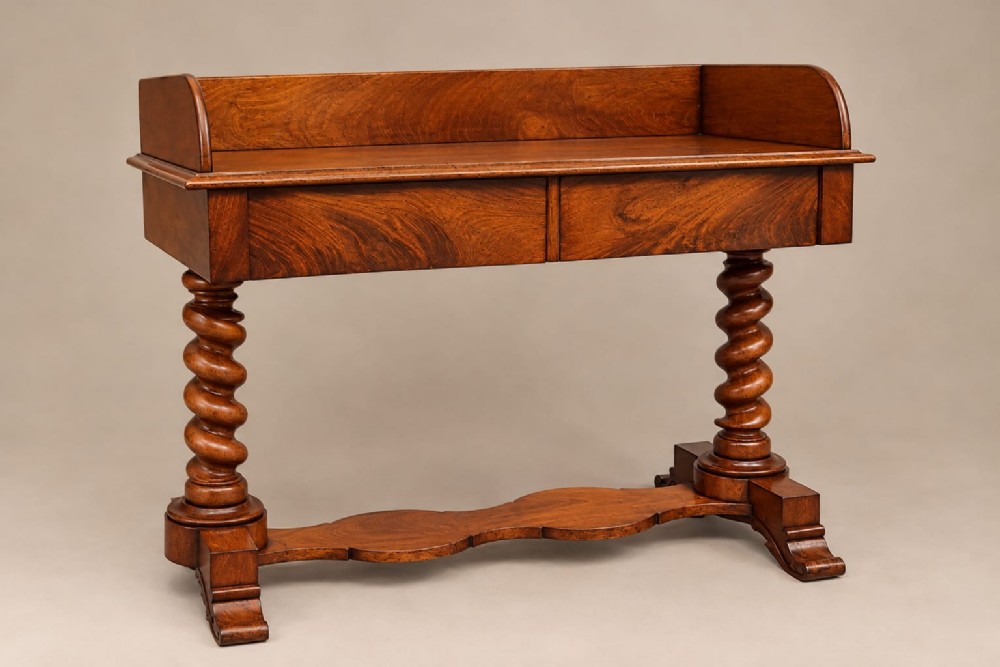 A Victorian warm brown mahogany washstand featuring a raised gallery back, two front drawers, barley twist legs, and a contoured serpentine base.