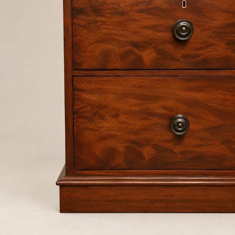 A Victorian mahogany double wardrobe featuring two arched panel doors set above a base with two short drawers and one long drawer. View IV