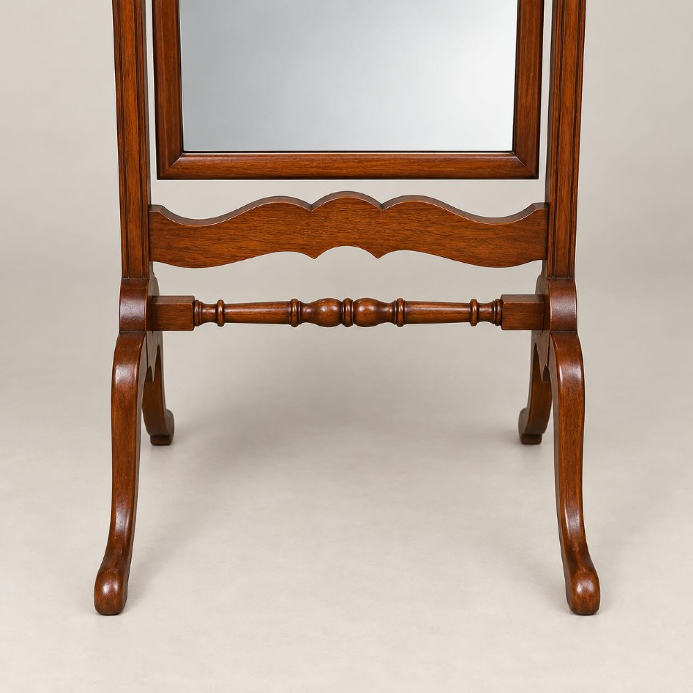 A 1920s full-length mahogany cheval mirror featuring an arched top frame, upright side posts with finials, turned cross-stretcher, and splayed feet. View II