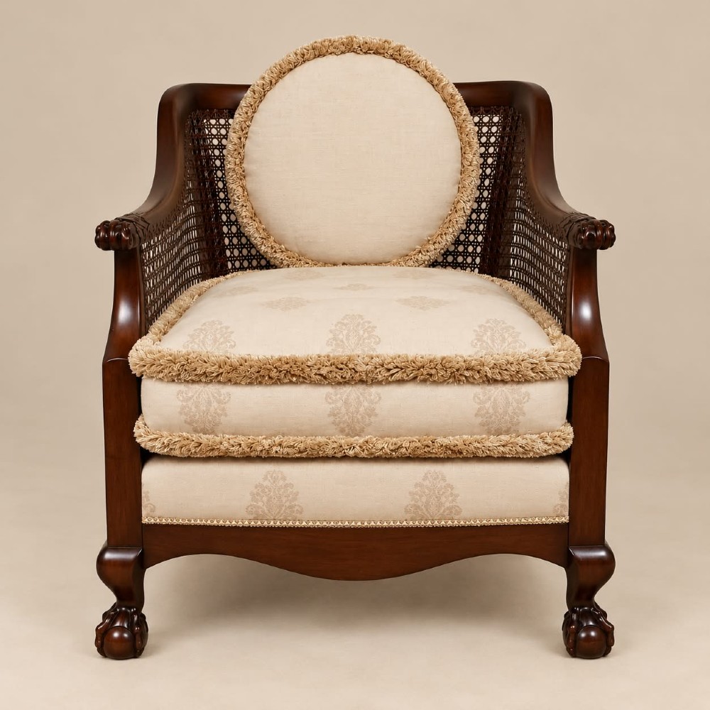 A pair of 1920s mahogany tub chairs featuring woven cane side panels, carved claw and ball feet, and cream upholstered cushions with matching circular accent pillows. View VII