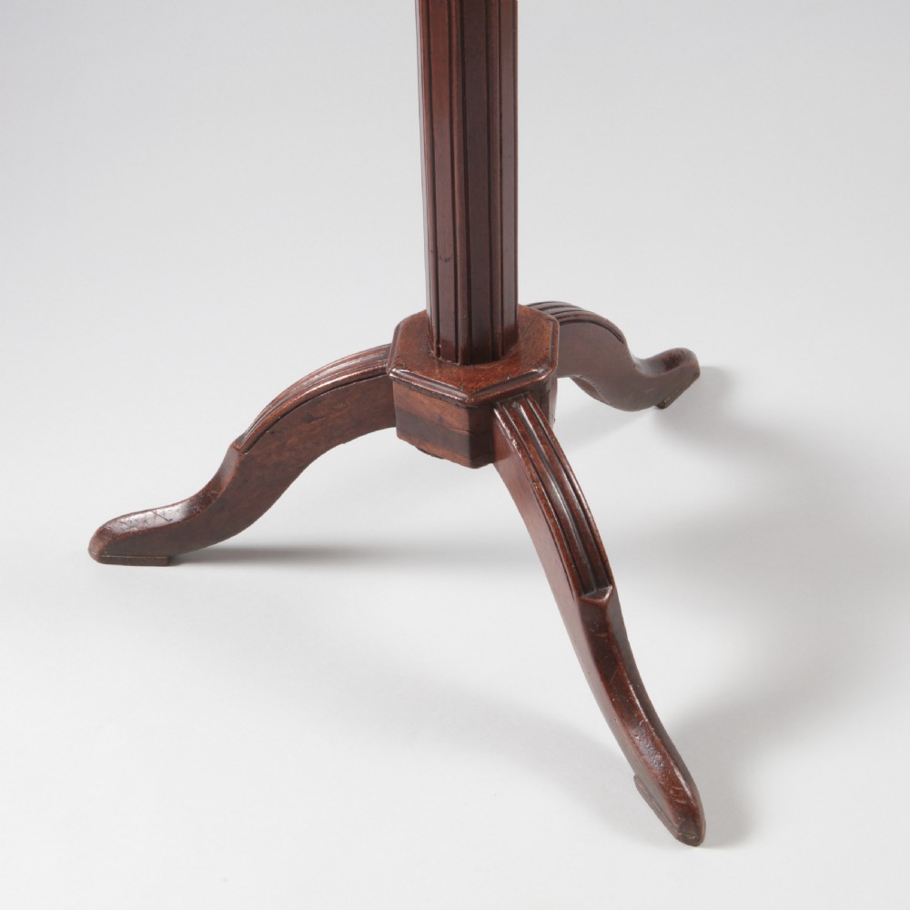 A Louis XVI style mahogany wine table featuring a circular grey marble top enclosed by a pierced brass gallery, supported on a fluted central pedestal and tripod legs. View III