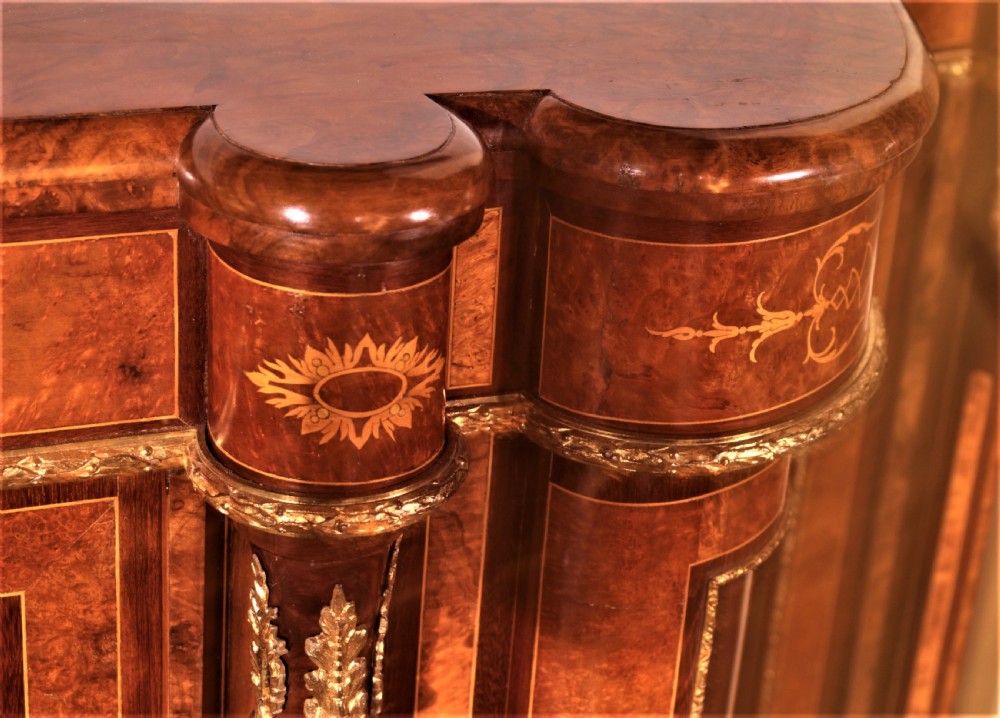 An antique Victorian burr walnut credenza featuring glazed end display doors, intricate marquetry inlay, gilt-metal mounts, and central cabinet doors adorned with oval painted porcelain plaques. View X