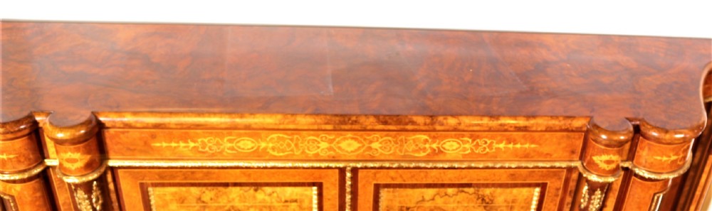 An antique Victorian burr walnut credenza featuring glazed end display doors, intricate marquetry inlay, gilt-metal mounts, and central cabinet doors adorned with oval painted porcelain plaques. View XI