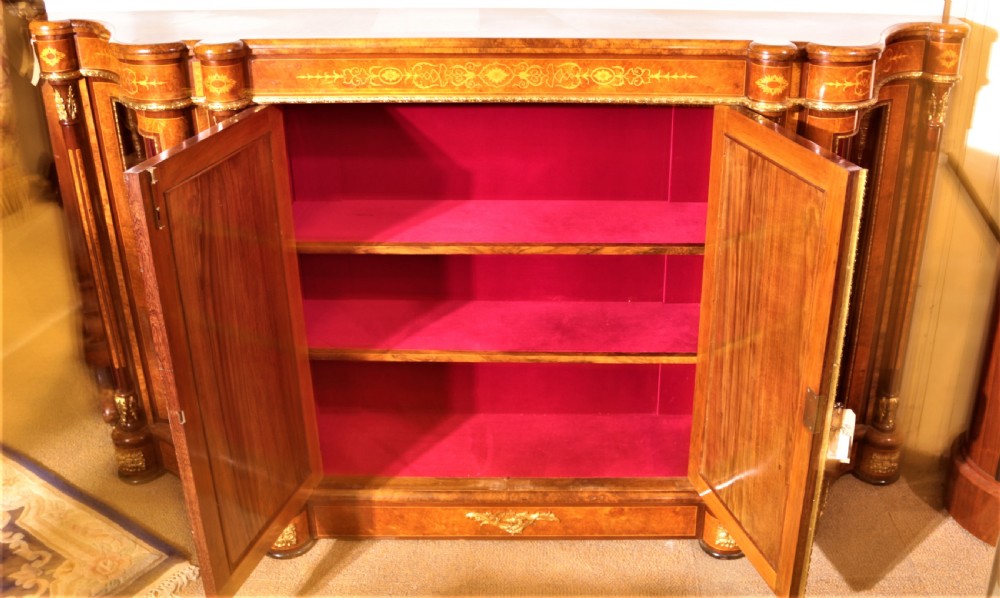 An antique Victorian burr walnut credenza featuring glazed end display doors, intricate marquetry inlay, gilt-metal mounts, and central cabinet doors adorned with oval painted porcelain plaques. View XIV