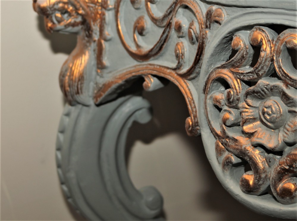 A Mid-Victorian painted grey and parcel-gilt console table featuring an intricate pierced scrollwork crest, lion mask carvings, and cabriole legs. View VI