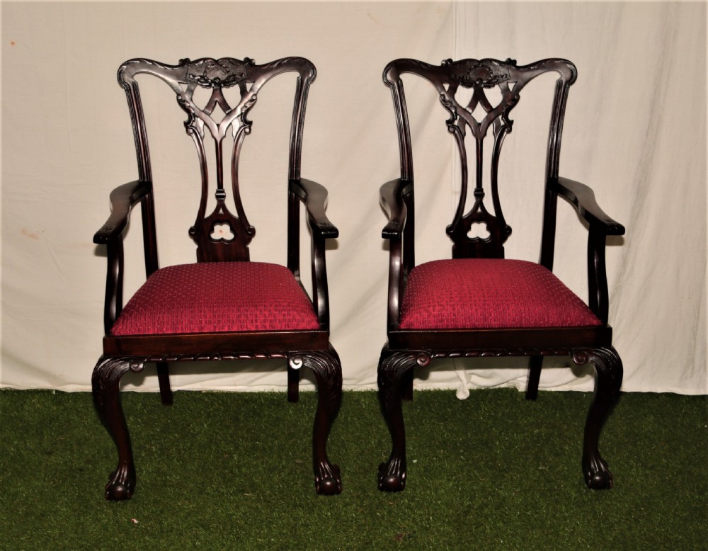 A set of eight dark mahogany Chippendale style dining chairs featuring red upholstered drop-in seats, pierced splats, and carved cabriole legs with ball-and-claw feet. View II