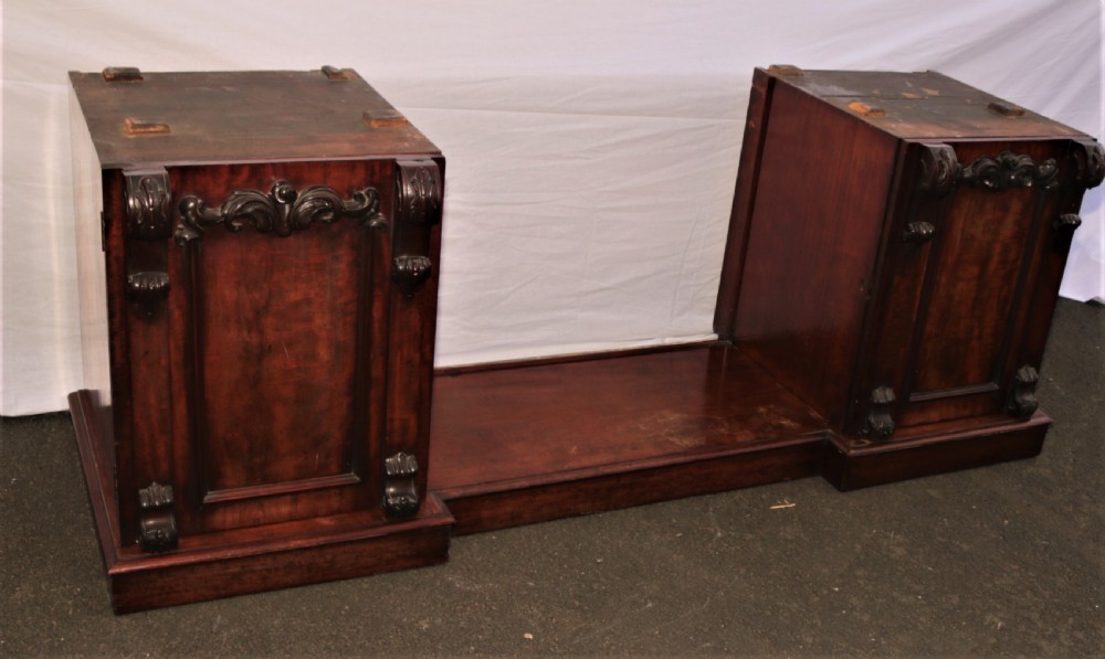 A Victorian dark mahogany sideboard featuring a large carved rococo backboard, flat serving surface, and two pedestal side cupboards. View III
