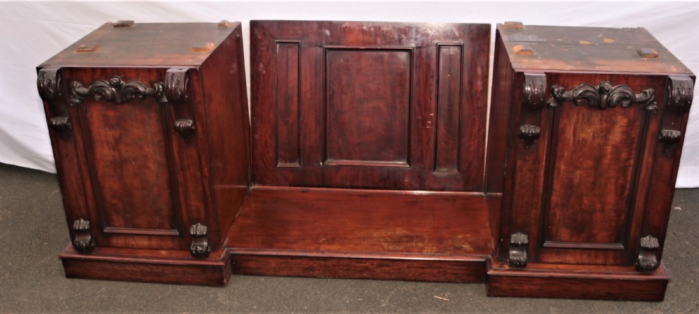A Victorian dark mahogany sideboard featuring a large carved rococo backboard, flat serving surface, and two pedestal side cupboards. View IV