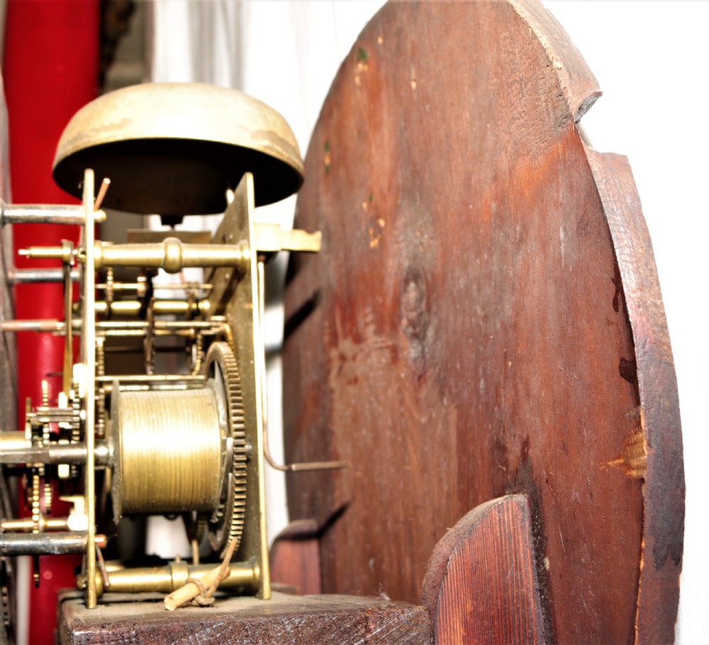A Victorian flame mahogany drumhead longcase clock featuring a circular hood, Roman numeral dial, and a tapered trunk flanked by turned columns. View XIII