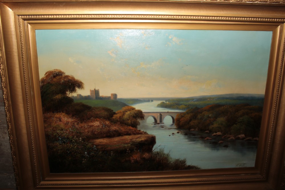 A framed landscape oil painting on canvas depicting Richmond Castle, a stone river bridge, and dense foliage beneath a soft blue sky. View II