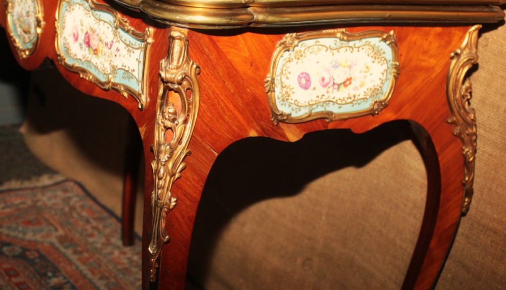 A mid-Victorian kingwood games table featuring cabriole legs, ornate gilt-bronze ormolu mounts, and inlaid porcelain plaques depicting floral scenes. View IV