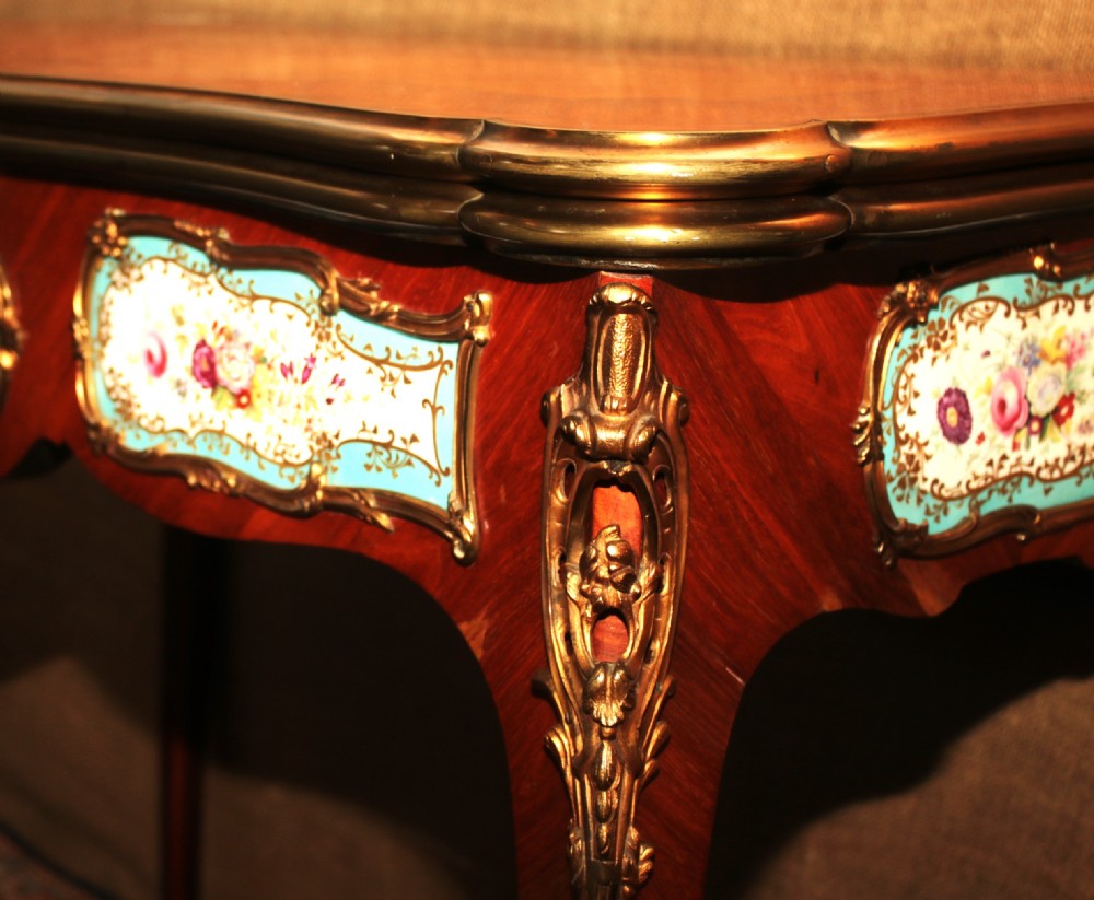 A mid-Victorian kingwood games table featuring cabriole legs, ornate gilt-bronze ormolu mounts, and inlaid porcelain plaques depicting floral scenes. View VIII