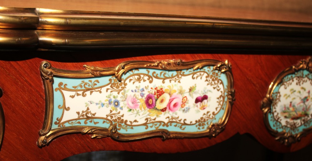 A mid-Victorian kingwood games table featuring cabriole legs, ornate gilt-bronze ormolu mounts, and inlaid porcelain plaques depicting floral scenes. View IX