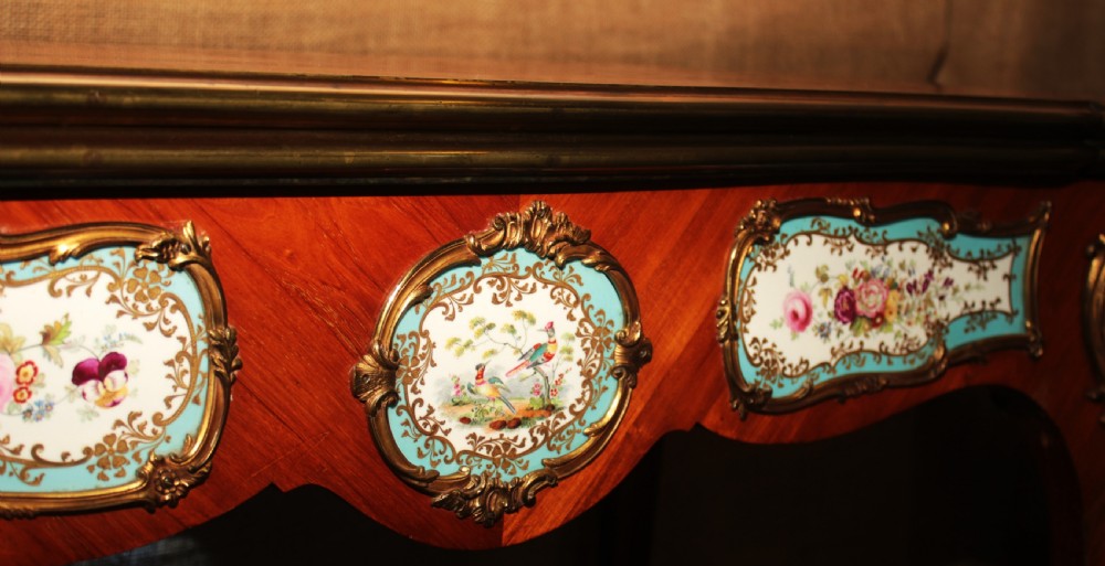 A mid-Victorian kingwood games table featuring cabriole legs, ornate gilt-bronze ormolu mounts, and inlaid porcelain plaques depicting floral scenes. View X