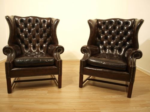 A Pair of Brown Leather George III Style Wing Armchairs