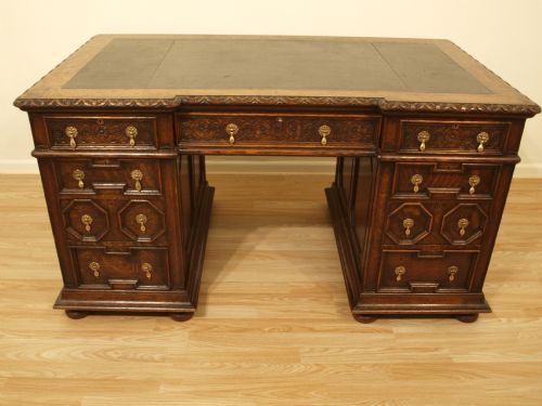 A Jacobean Revival Oak Pedestal Desk by Gillows of Lancaster