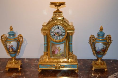 A French 19th Century Gilt Bronze & Sevres Clock Garniture