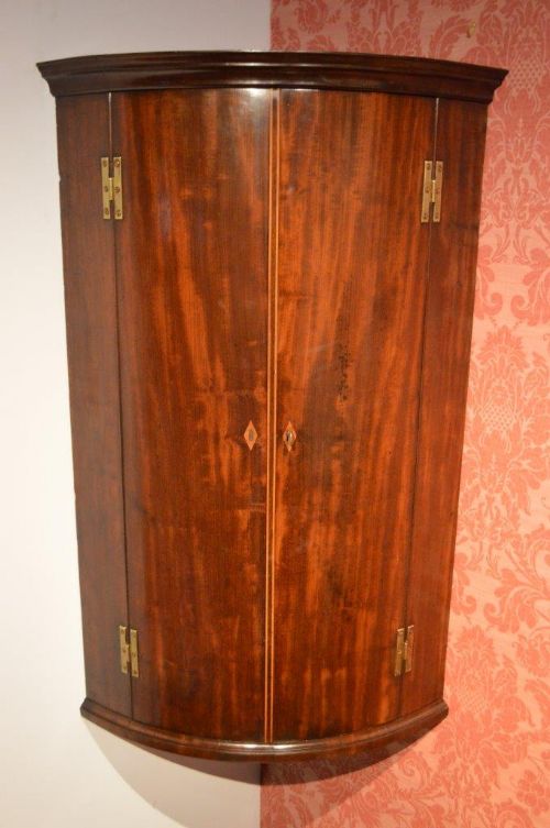 A Mahogany George III Period Bow Front Corner Cupboard