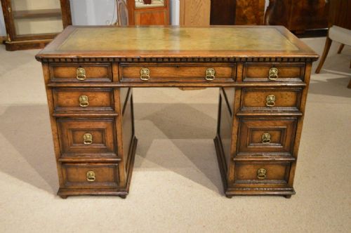 A Jacobean Revival Distressed Solid Oak Knee Hole Desk