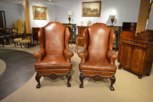 A Good and Large Pair of Chippendale Style Brown Leather Wing Armchairs.