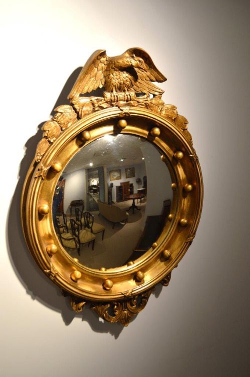 A Carved Gilt-wood and Gesso Regency Style Convex Mirror.