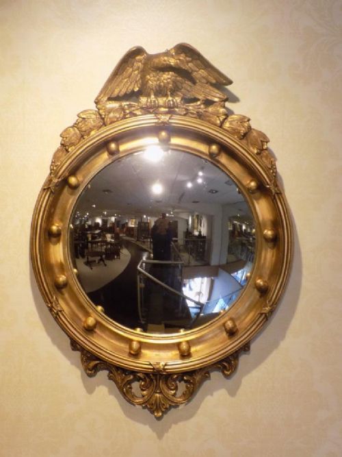 A Carved Gilt-wood and Gesso Regency Style Convex Mirror.